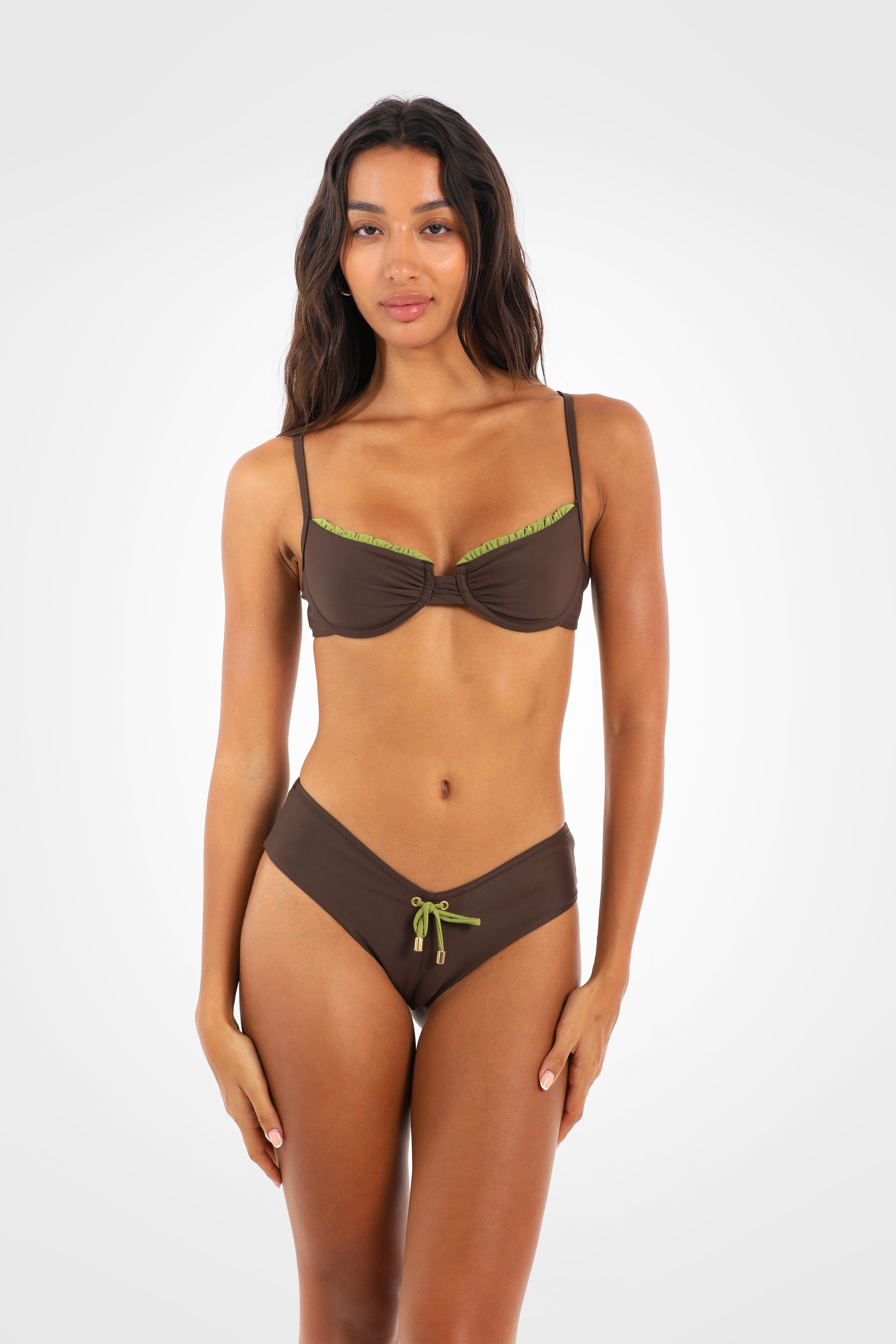 Front view of the Aruna Cheeky Shortie Bikini Bottoms in rich chocolate brown featuring a flattering V-front, wide sides, pistachio-green ties, and decorative front bow.