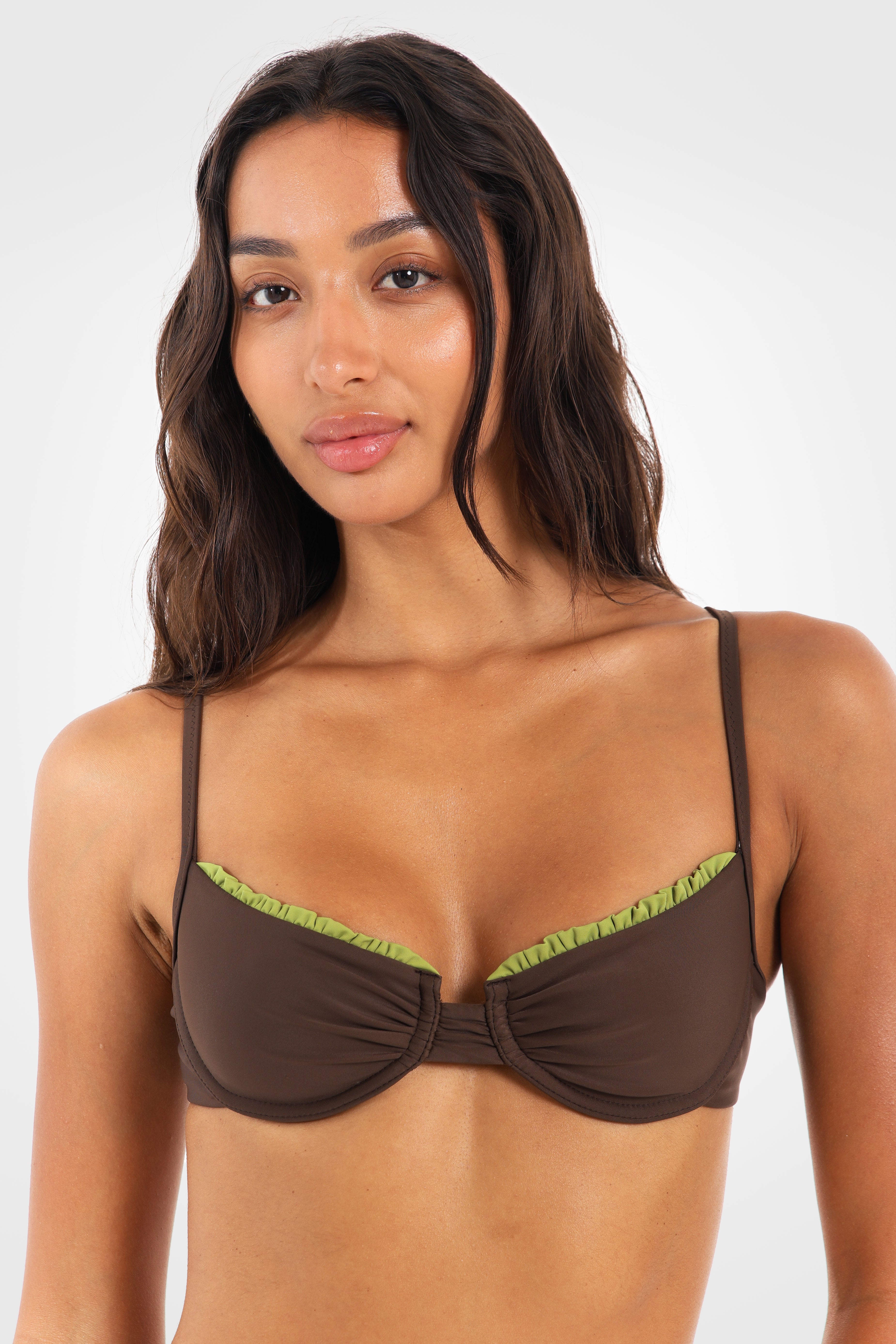 Close-up front view of the Aruna Underwire Bikini Top showcasing supportive underwire cups, feminine ruched edging, and pistachio-green contrast straps.