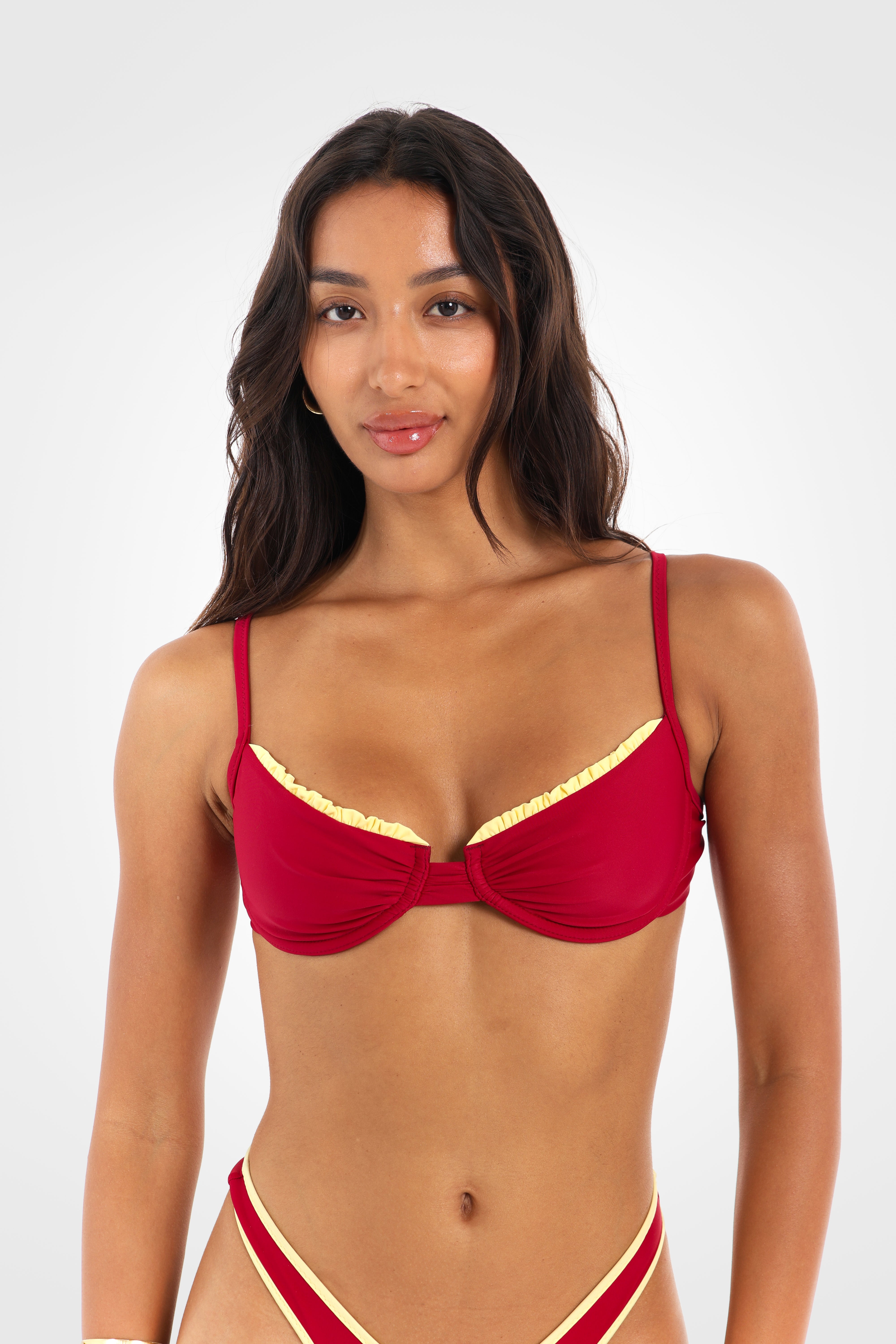 Close-up front view of the Indra Underwire Bikini Top highlighting the supportive underwire design, lemon yellow ruched edging, and sculpting bra-style fit.