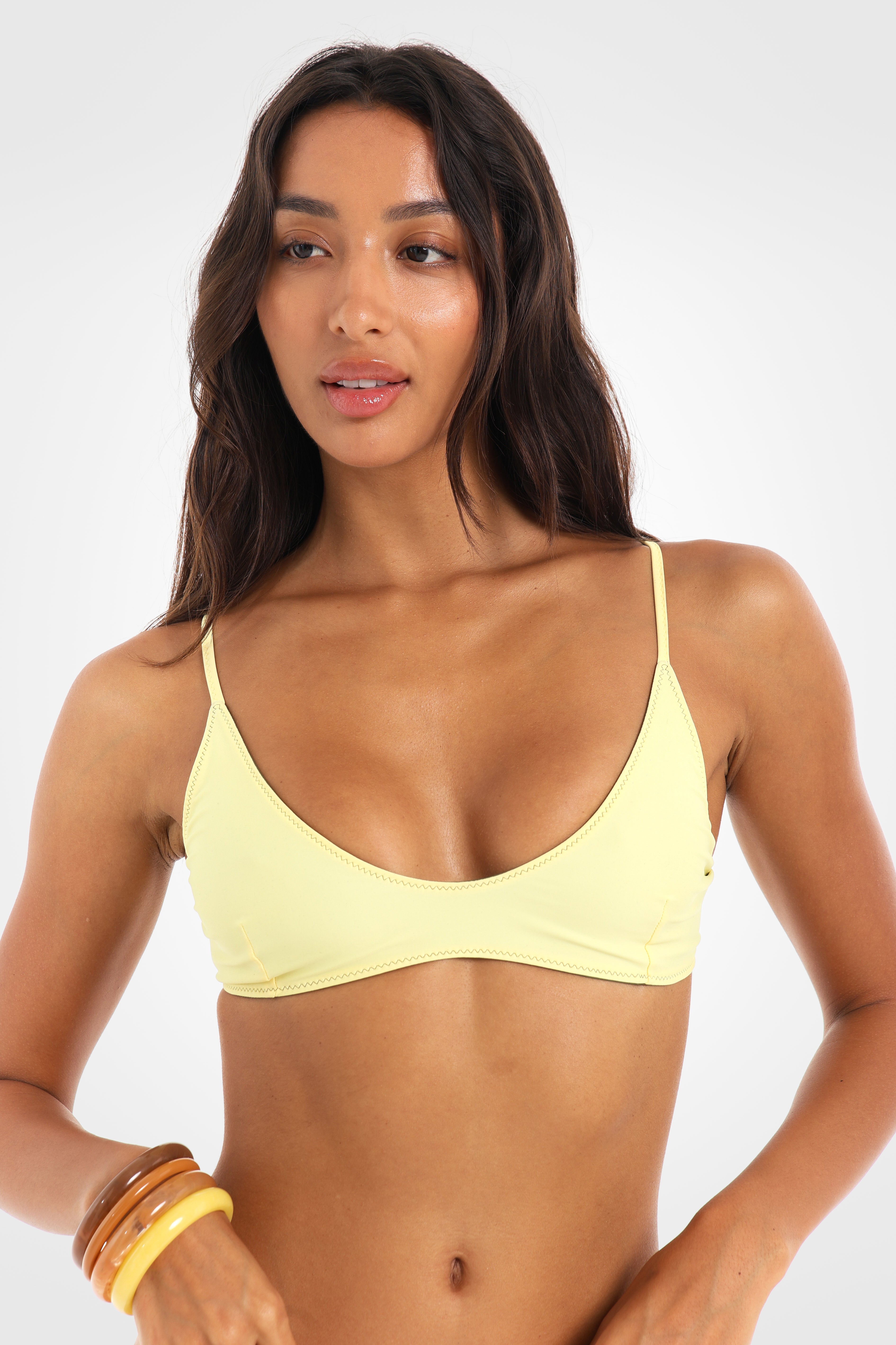 Close-up front view of the Mossii Reversible Scoop Bikini Top in the butter yellow reverse, showcasing the scoop neckline and clean, minimal silhouette.