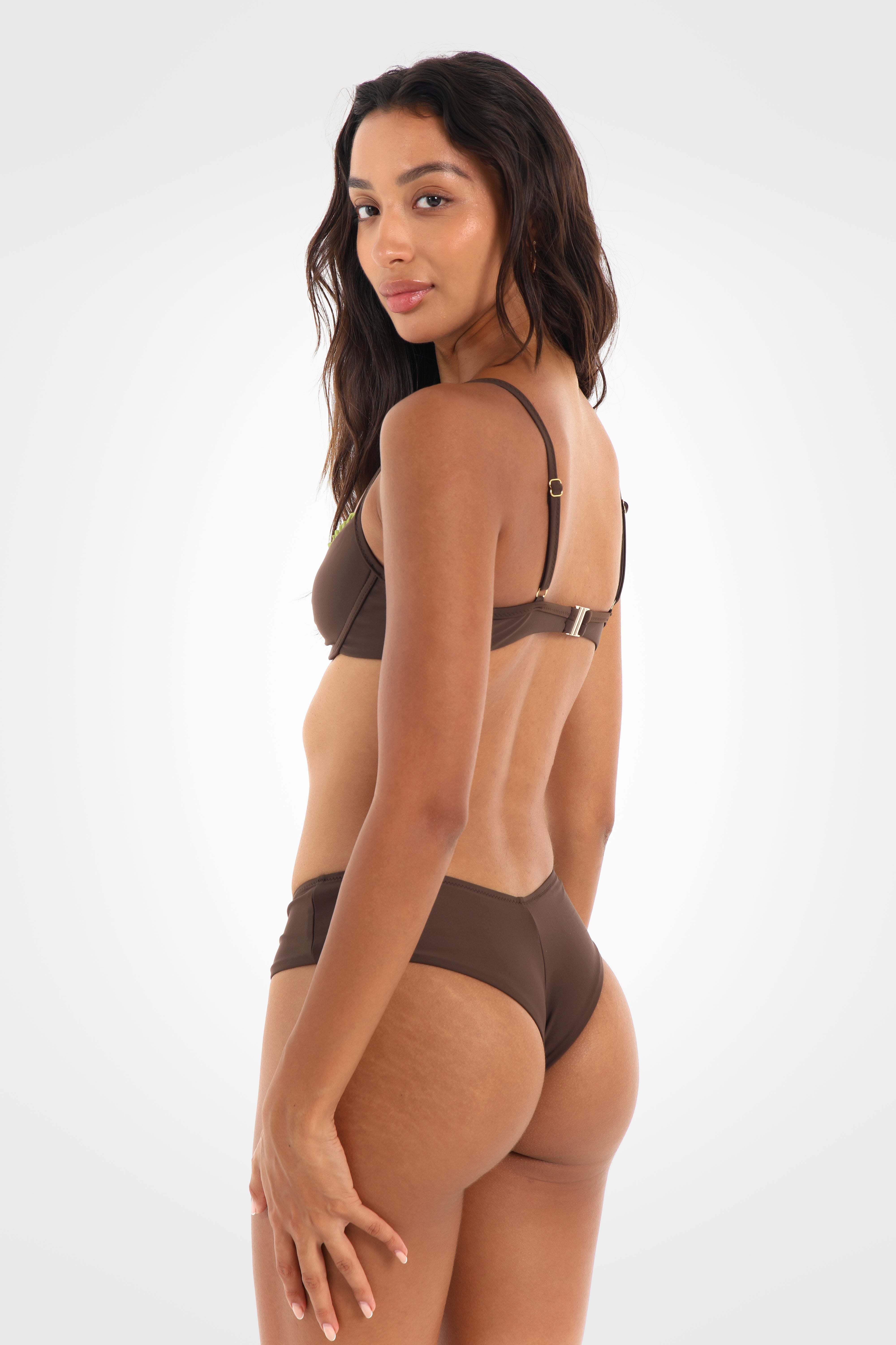 Side view of the Aruna Cheeky Shortie Bikini Bottoms showcasing the cheeky fit, comfortable wide sides, and pistachio-green tie detail.
