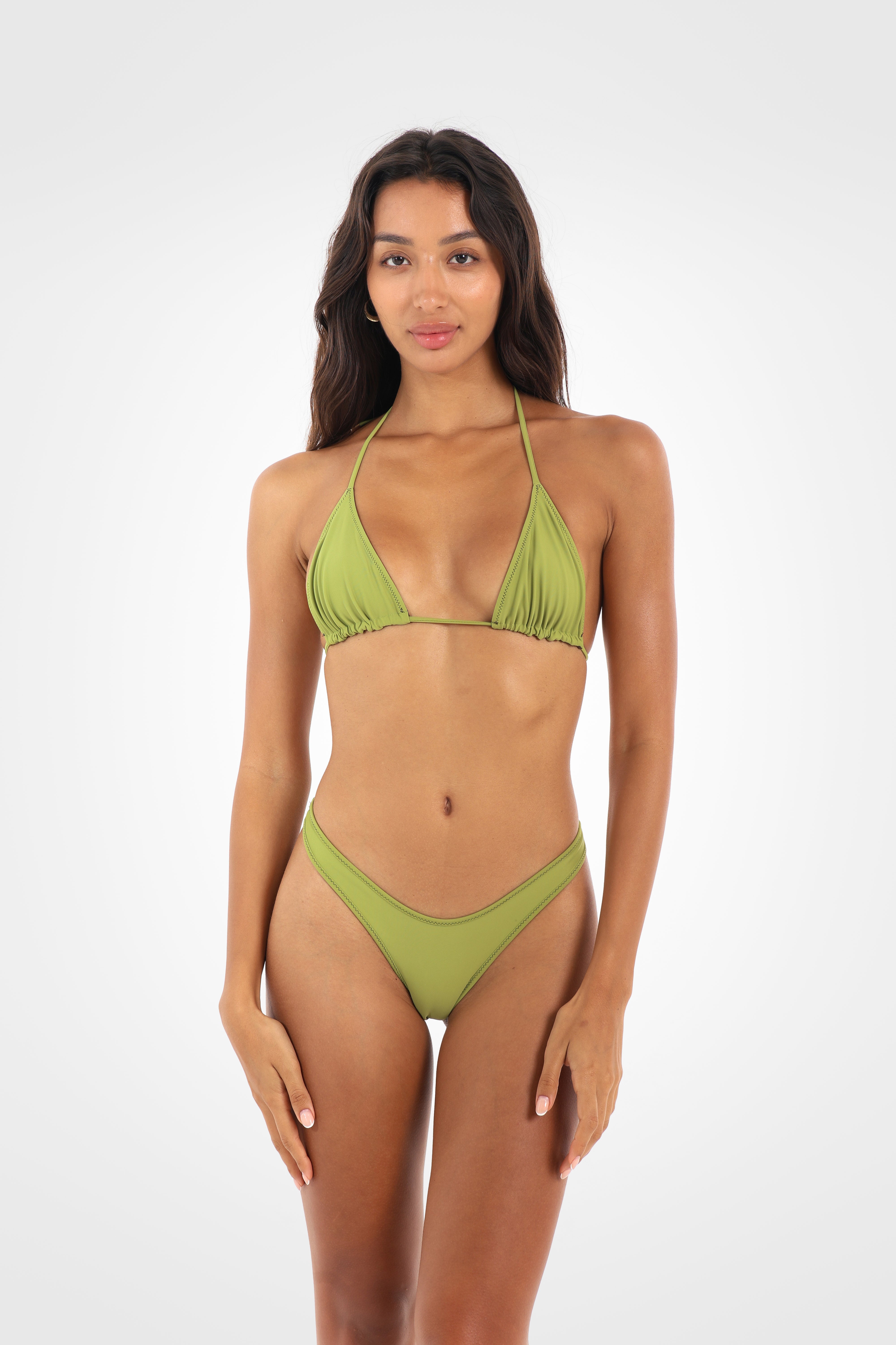 Full front view of the Aruna Reversible Classic Low Coverage Bikini Bottoms in the pistachio green reverse, showcasing the high-cut silhouette and sculpted low-coverage fit.