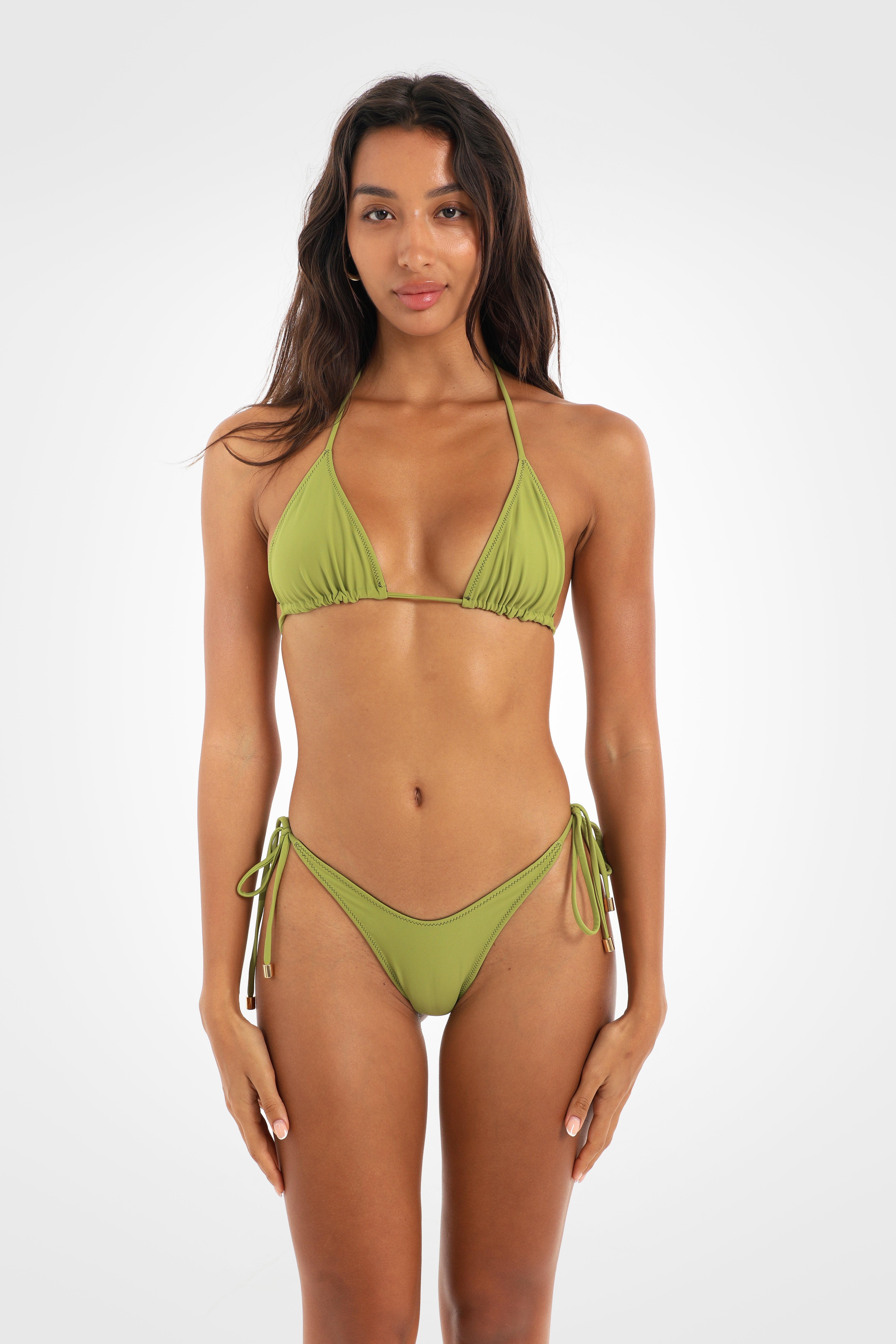 Front view of the Aruna Reversible Triangle Bikini Top in the pistachio green reverse featuring adjustable triangle cups, halter ties, and a classic reversible design.