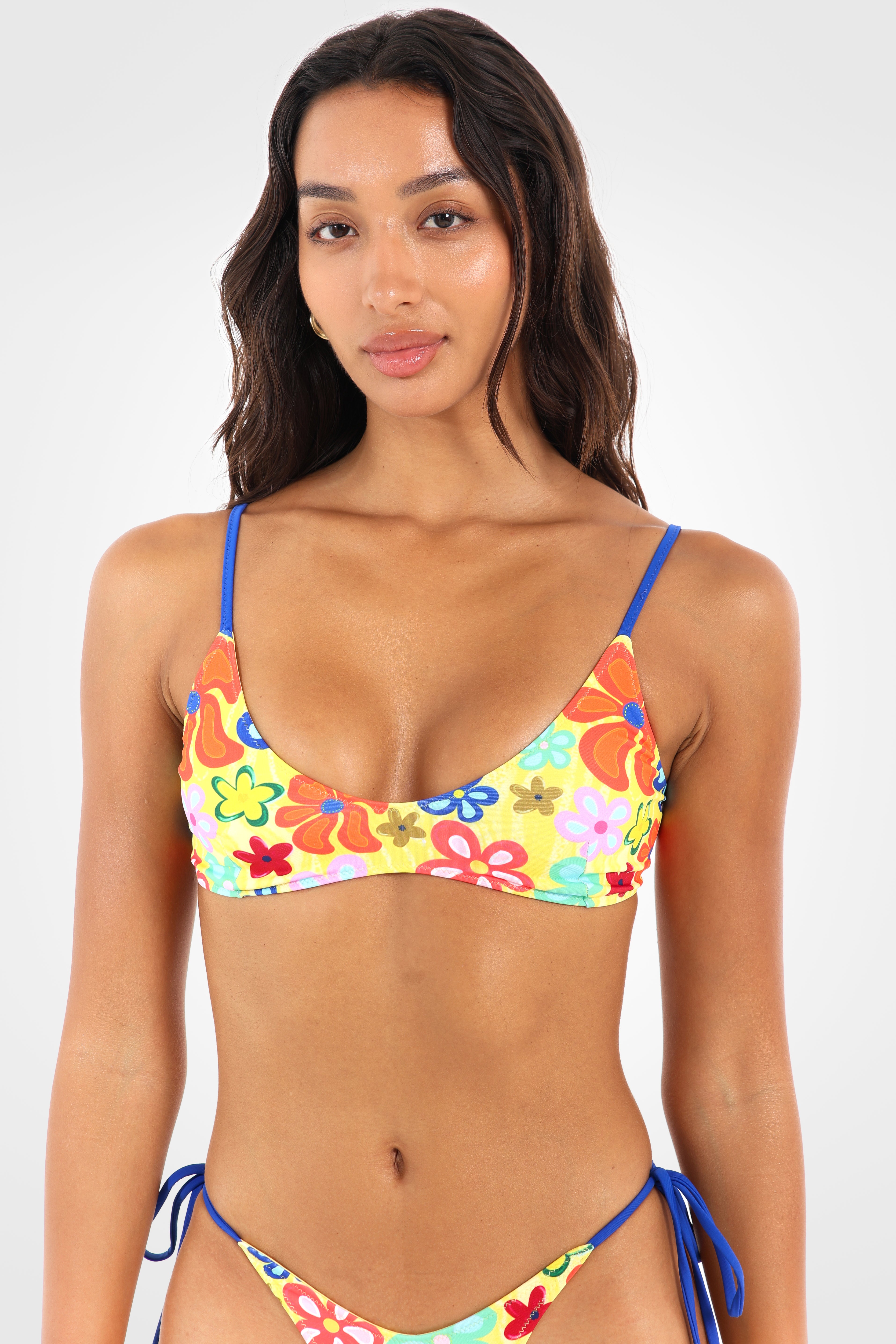 Close-up front view of the Fiolita Reversible Scoop Bikini Top highlighting the vibrant Fiolita wildflower print, flattering scoop neckline, and cobalt blue contrast straps.