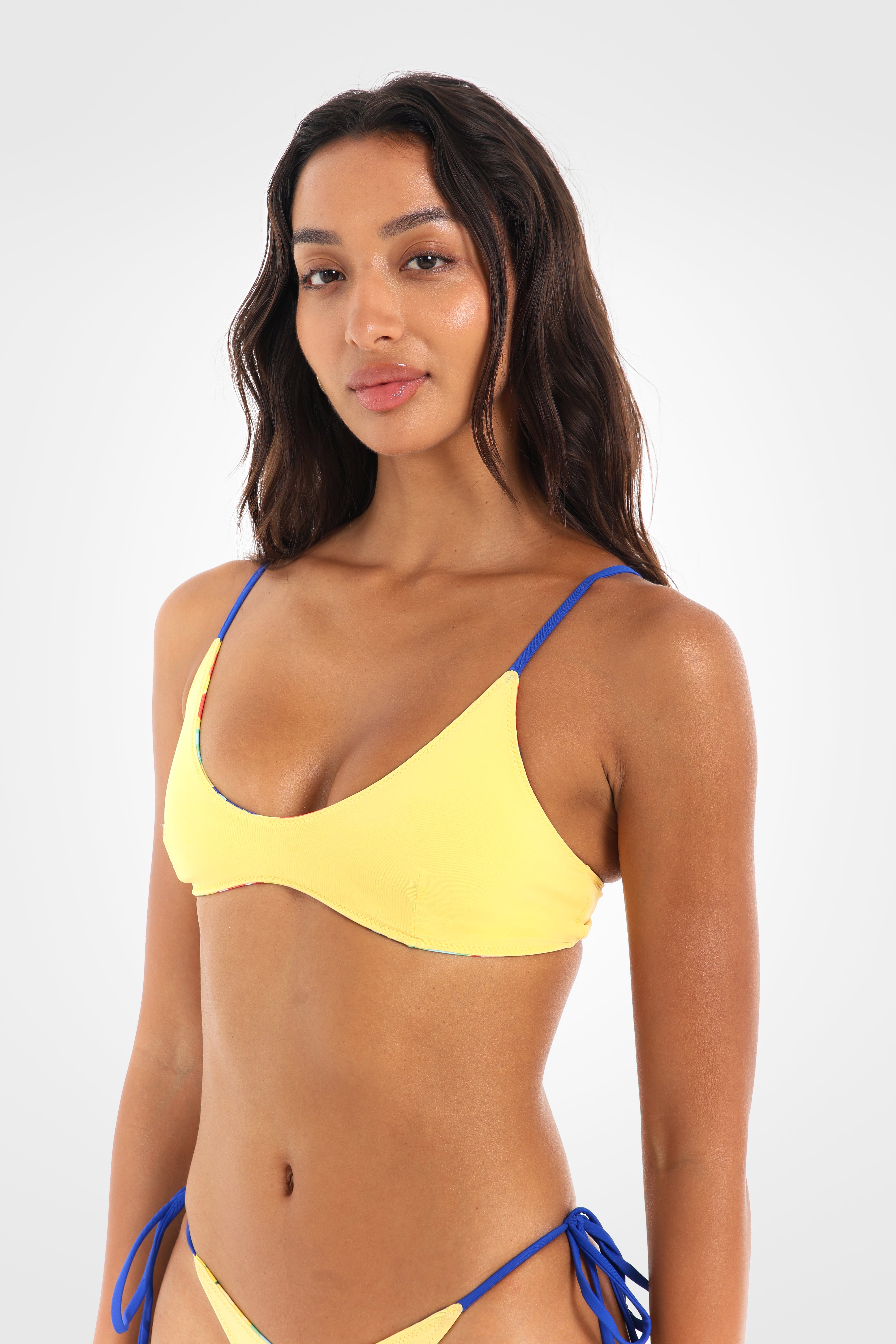 Close-up front view of the Fiolita Reversible Scoop Bikini Top in the vibrant yellow reverse highlighting the flattering scoop neckline and clean, minimal silhouette.