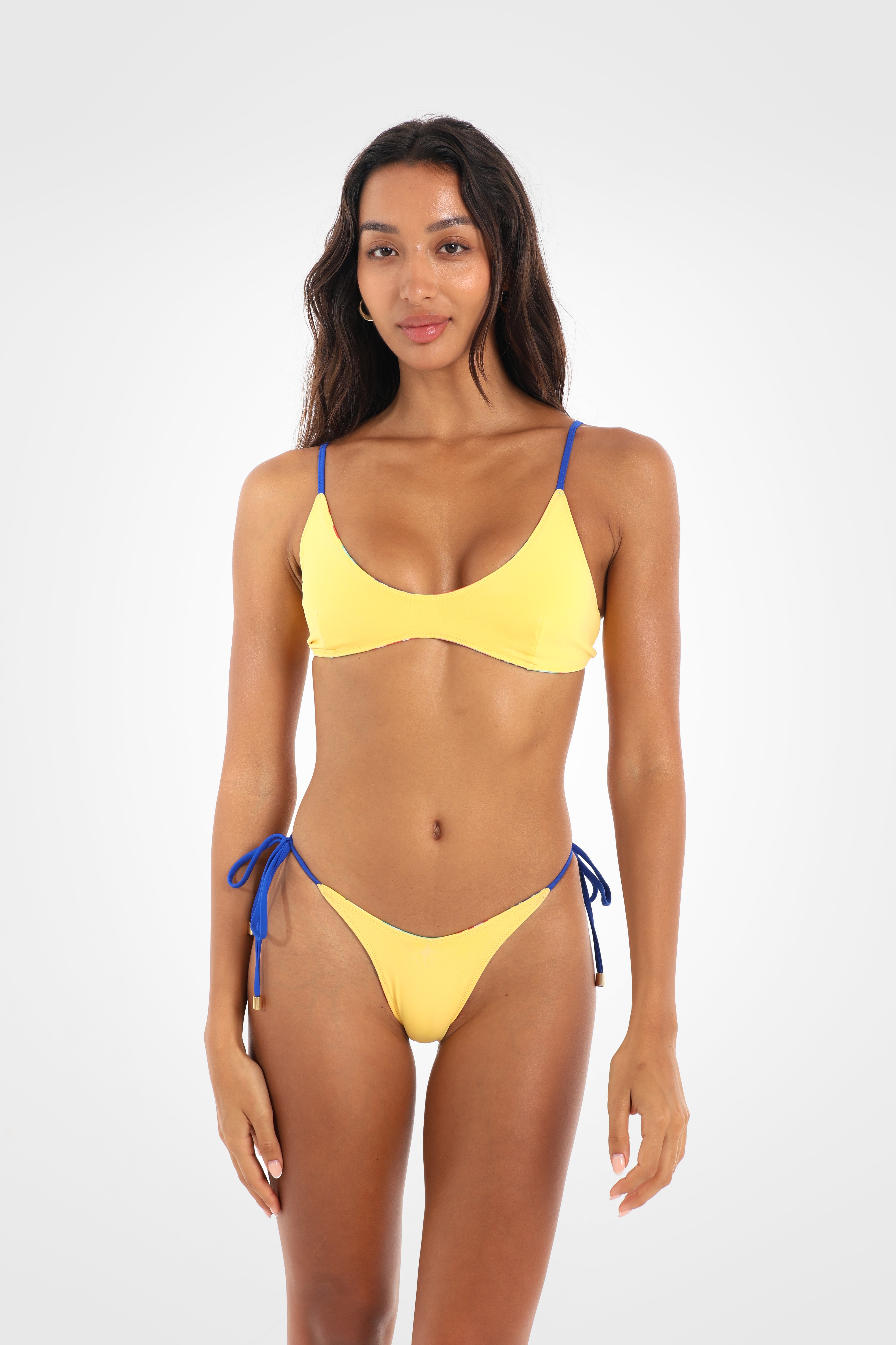 Front view of the Fiolita Reversible Scoop Bikini Top reversed to vibrant yellow featuring a soft scoop neckline and adjustable cobalt blue shoulder straps.