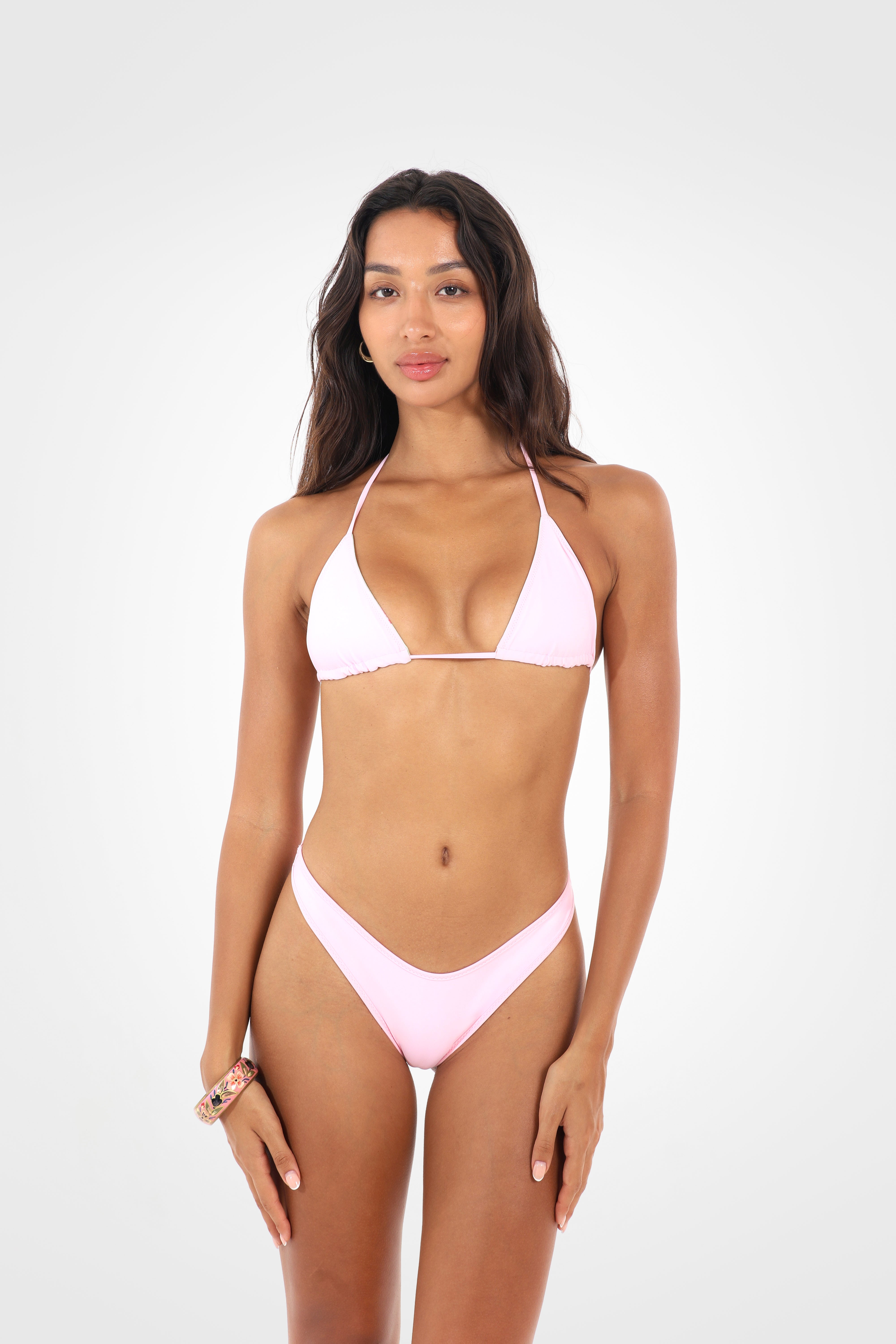 Front view of the Lumira reversible triangle bikini set in bubblegum pink with adjustable triangle top and matching bikini bottoms.