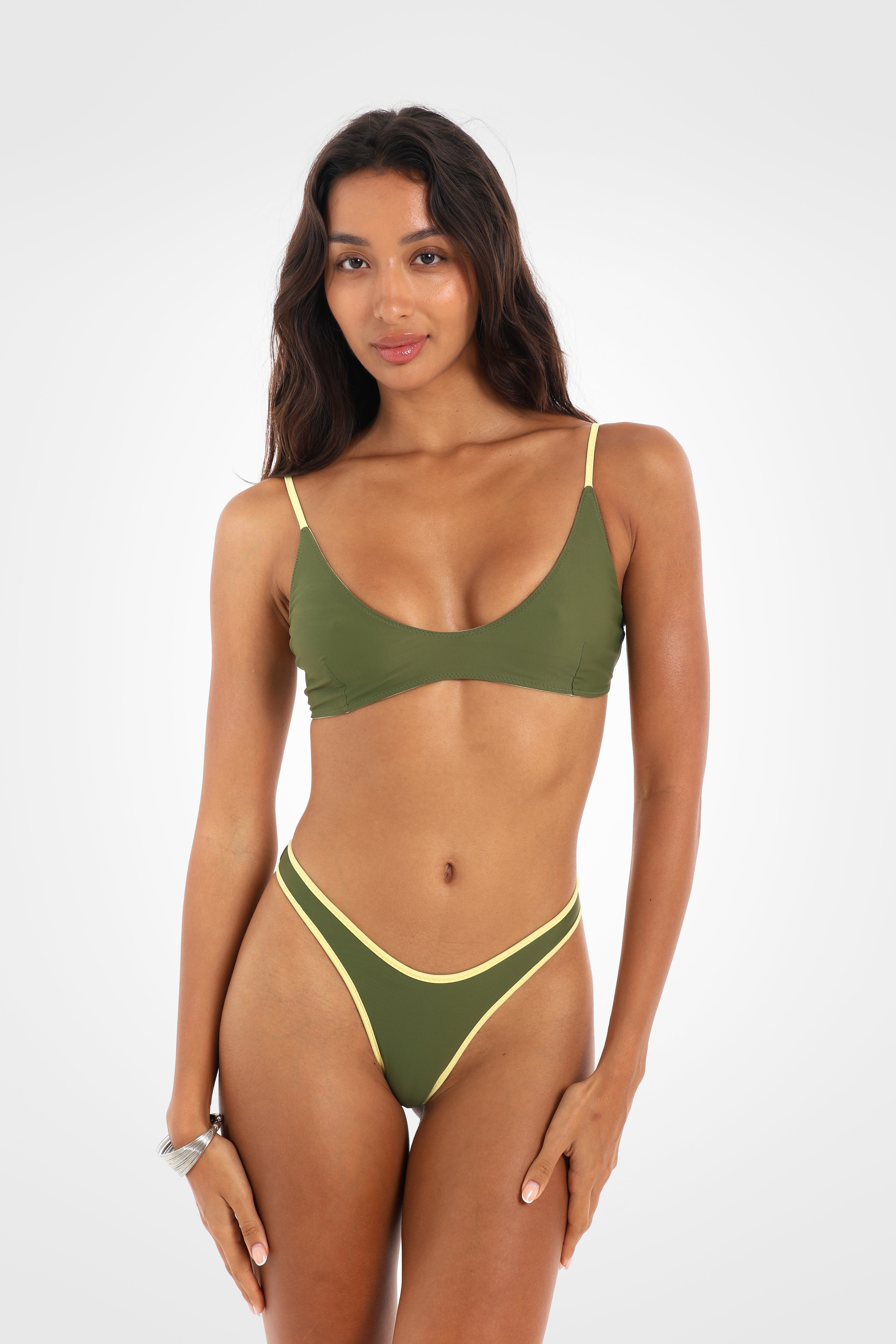 Front view of the Mossii Reversible Classic Low Coverage Bikini Bottoms in khaki green featuring a high-cut silhouette, fixed sides, and a sculpted cheeky fit with butter-yellow contrast binding.