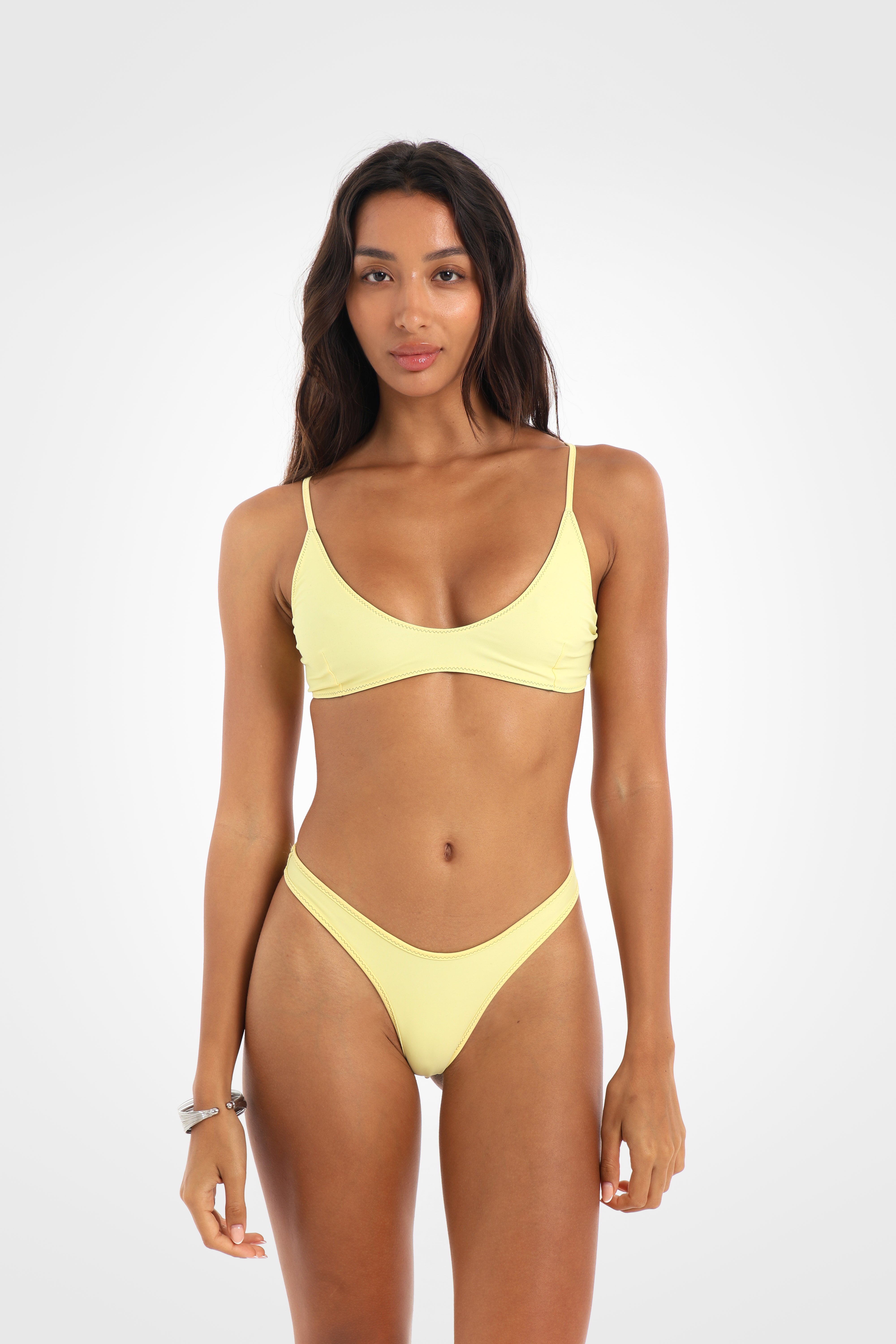 Front view of the Mossii Reversible Scoop Bikini Top reversed to butter yellow, featuring a soft scoop neckline and adjustable khaki green back tie.