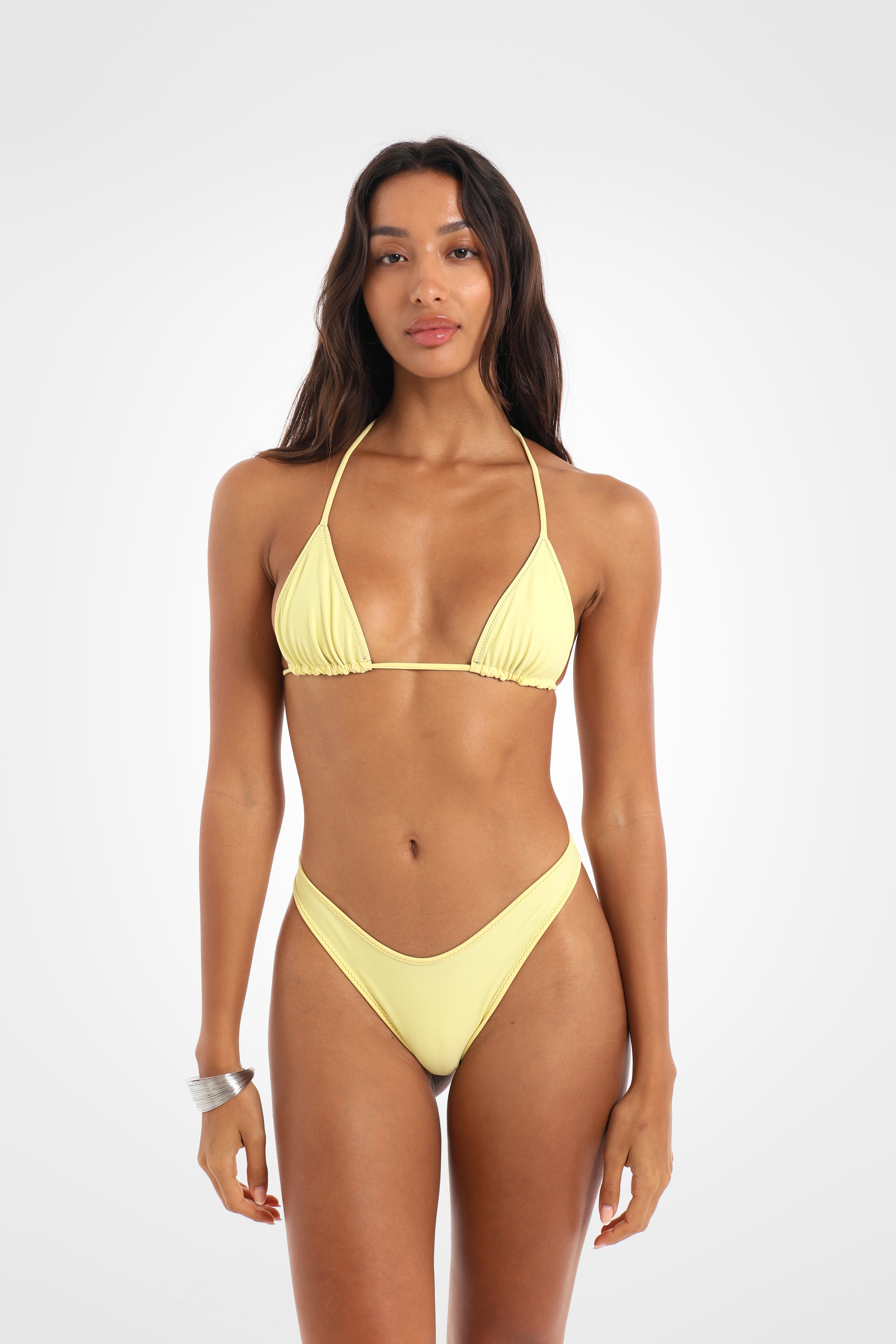 Front view of the Mossii Reversible Triangle Bikini Top reversed to butter yellow, featuring adjustable sliding triangle cups and khaki green contrast ties.